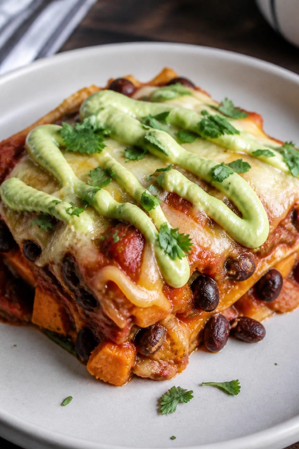 Sweet Potato Black Bean Enchilada Casserole with Avocado Crema