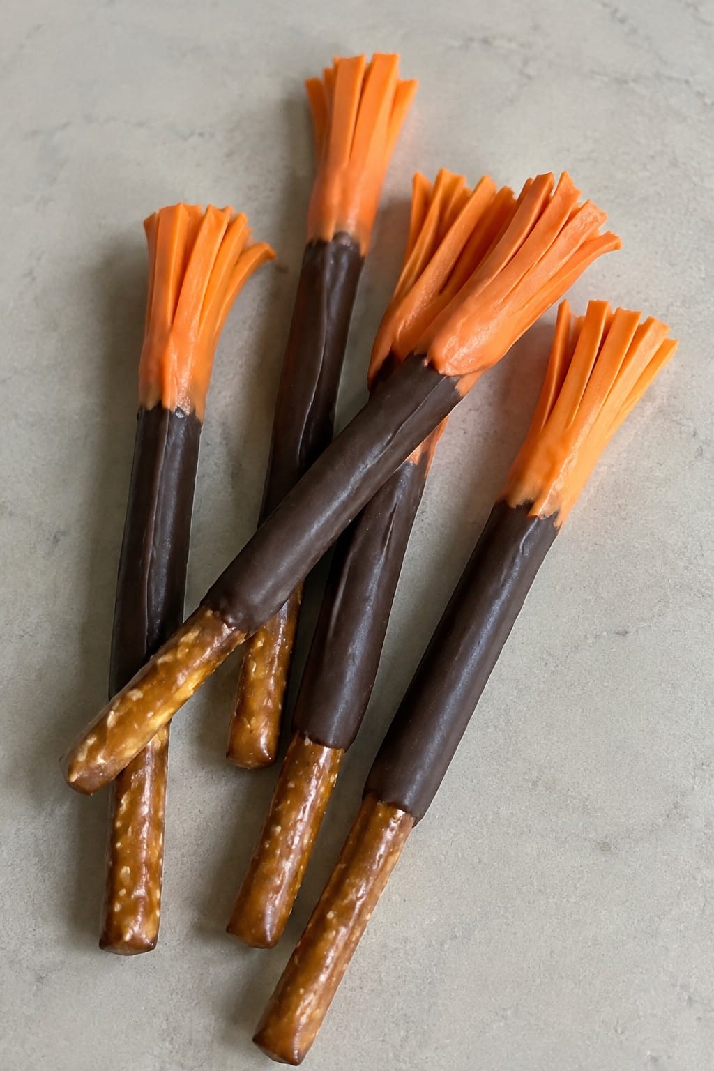 Chocolate-Dipped Pretzel Broomsticks with Orange Candy Melts