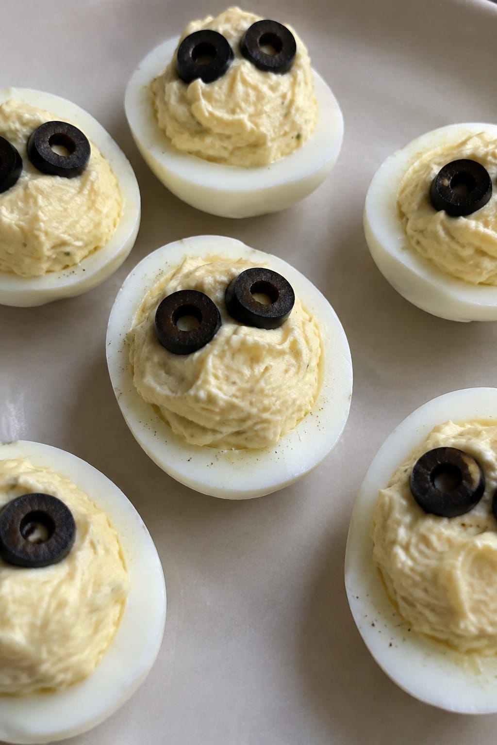 Ghostly Deviled Eggs Topped with Black Olive Eyes