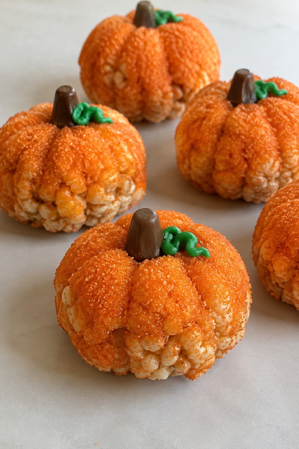 Pumpkin-Shaped Rice Krispie Treats Rolled in Orange Sugar