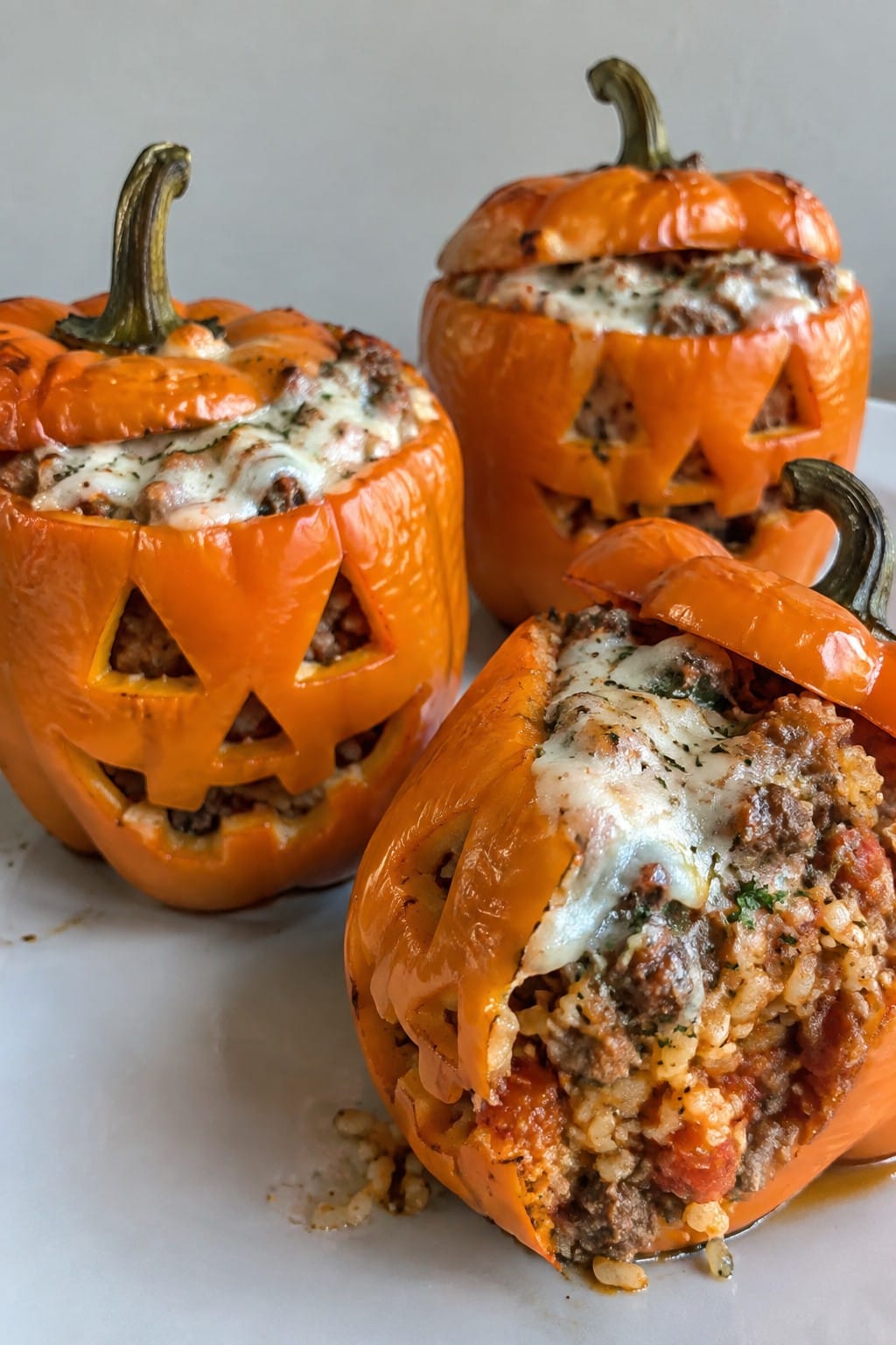 Jack-O’-Lantern Stuffed Bell Peppers with Sausage and Rice