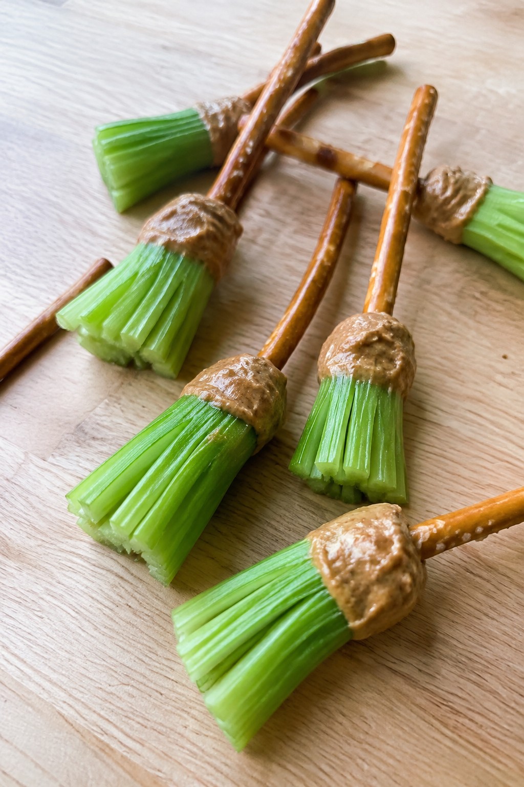 Witch's Broom Celery Sticks with Almond Butter and Pretzel Handles