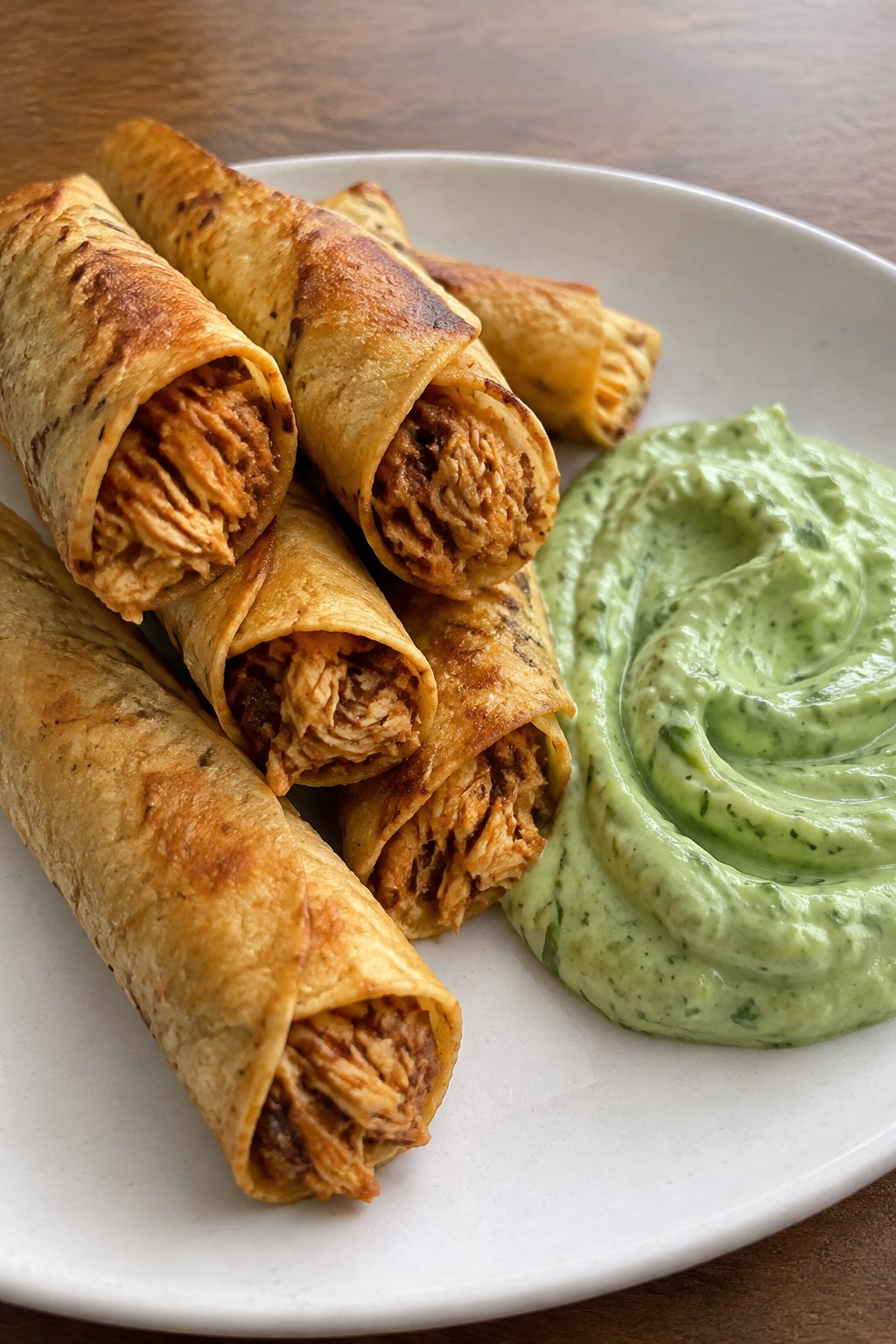 Smoky Chipotle Chicken Taquitos with Avocado Crema
