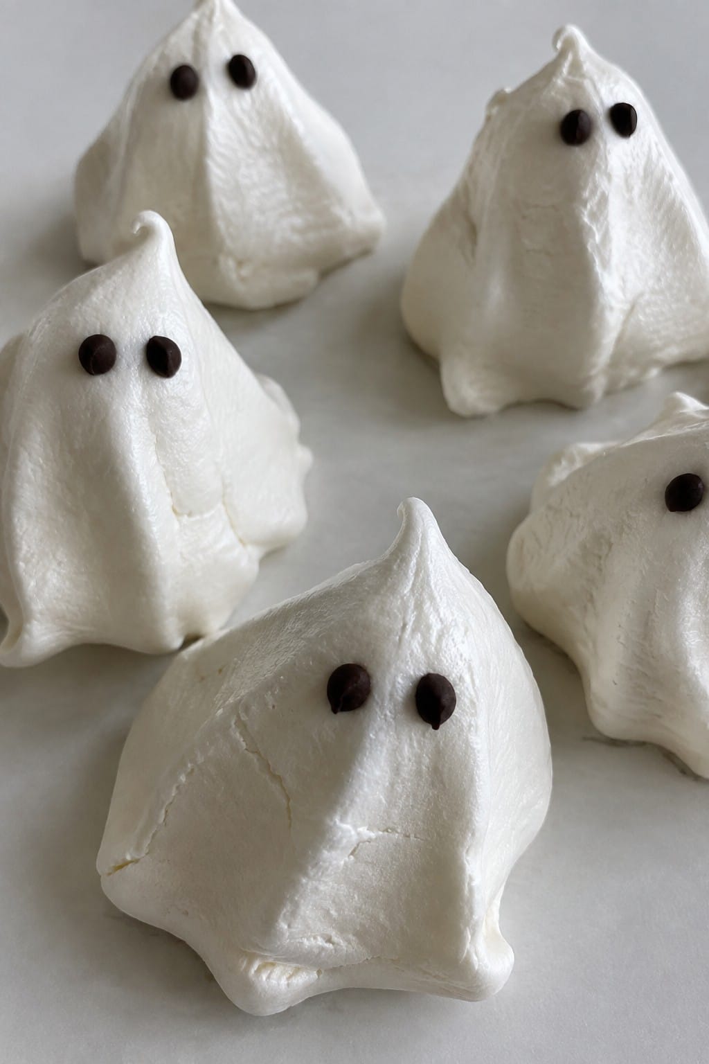 Ghost-Shaped Meringue Cookies with Mini Chocolate Chip Eyes