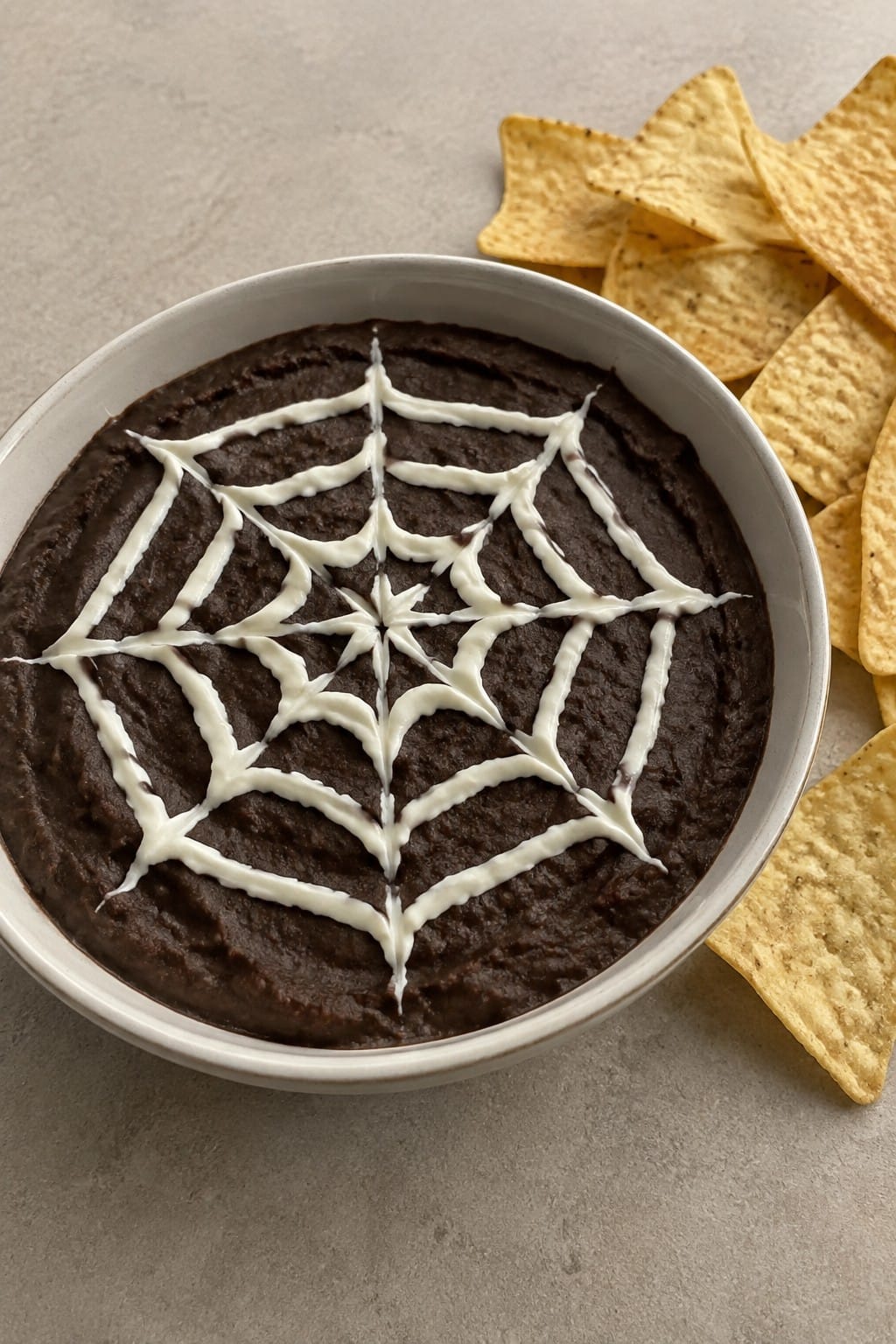 Spiderweb Black Bean Dip with Tortilla Chips
