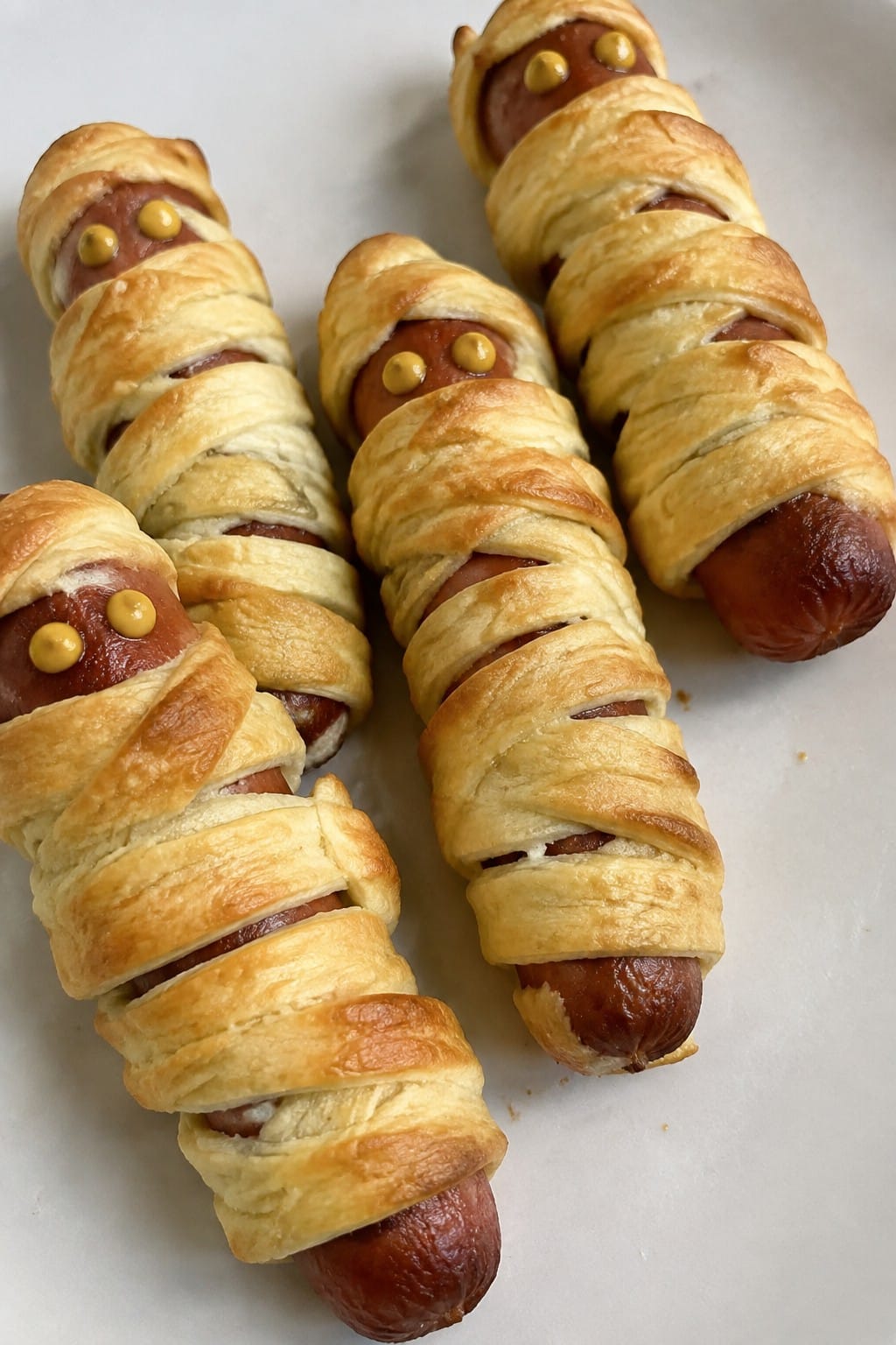 Mummy Hot Dog Roll-Ups with Mustard Eyes