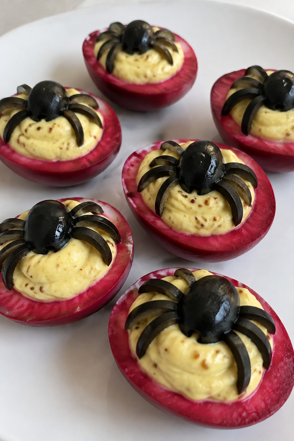 Bloody Beet Deviled Eggs with Olive Spiders