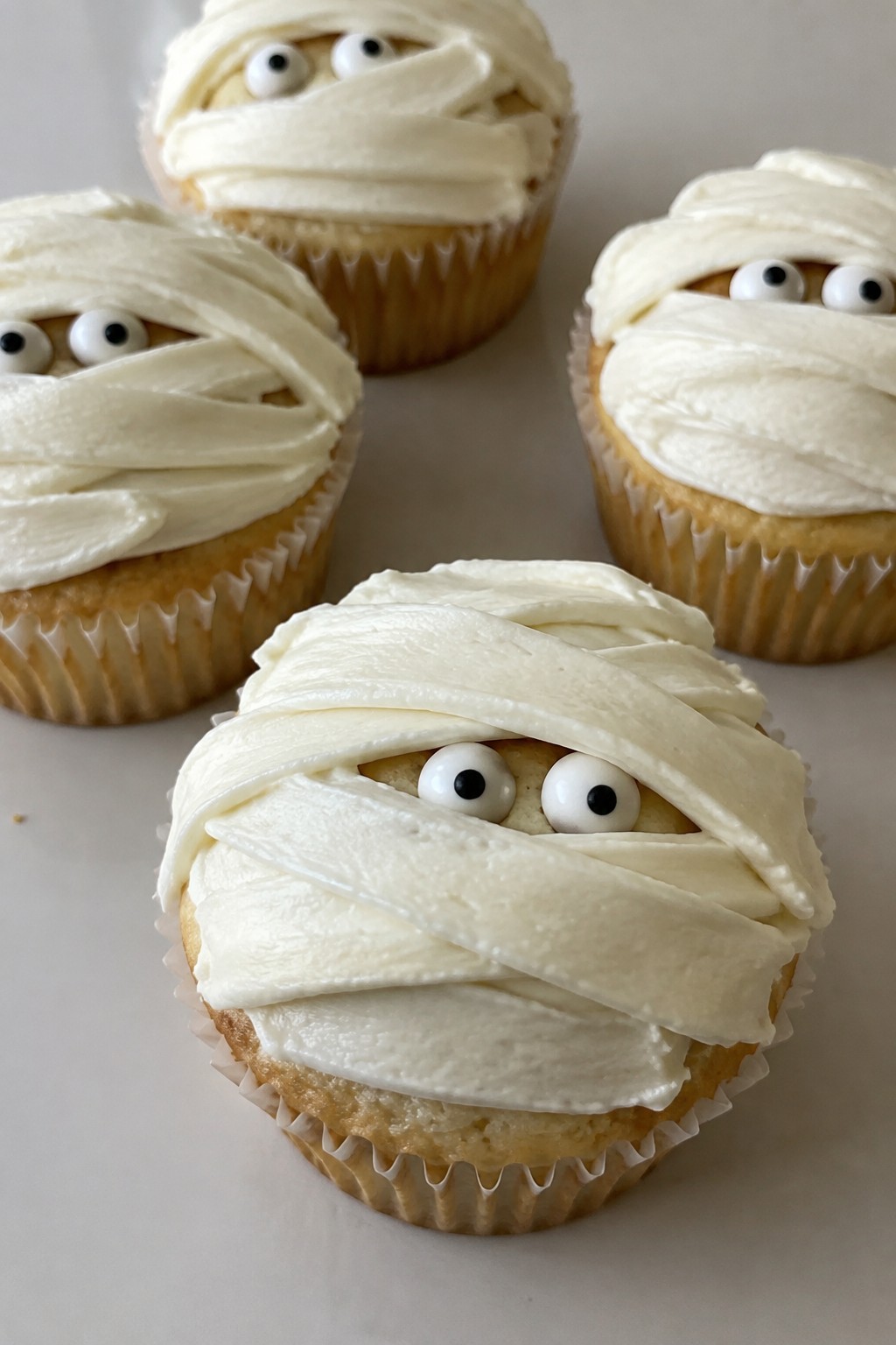 Mummy Wrapped Vanilla Cupcakes with Cream Cheese Icing