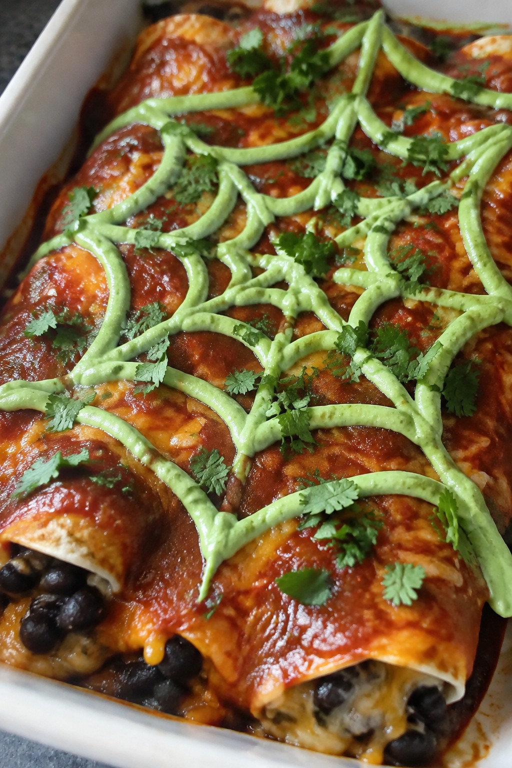 Spiderweb Black Bean Enchiladas with Avocado Crema