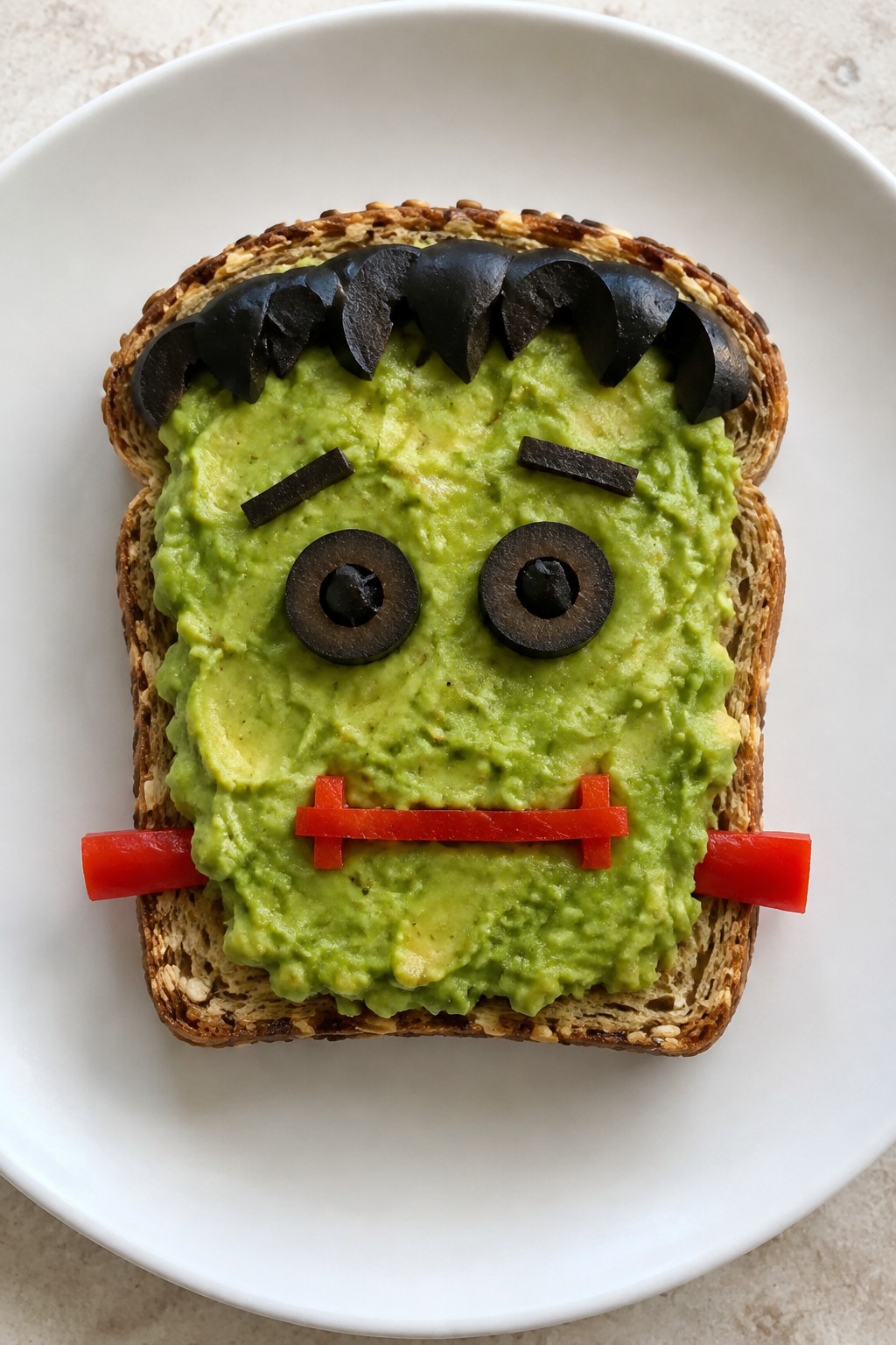 Frankenstein Avocado Toast on Whole Grain Bread