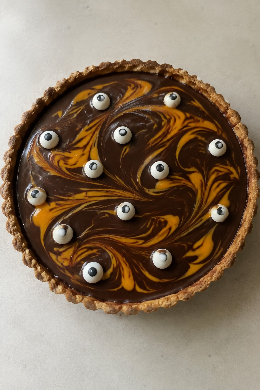 Chocolate Ganache Tart with Orange Curd Swirls and Candy Eyeballs