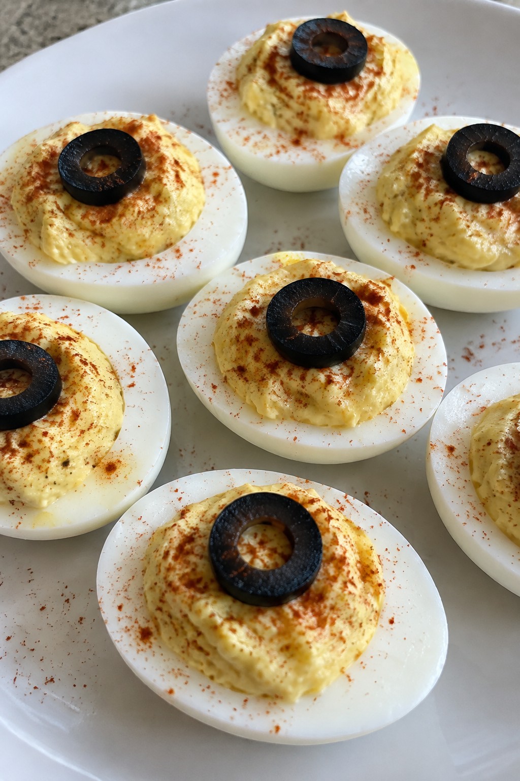 Monster Eye Deviled Eggs with Black Olive and Paprika Garnish