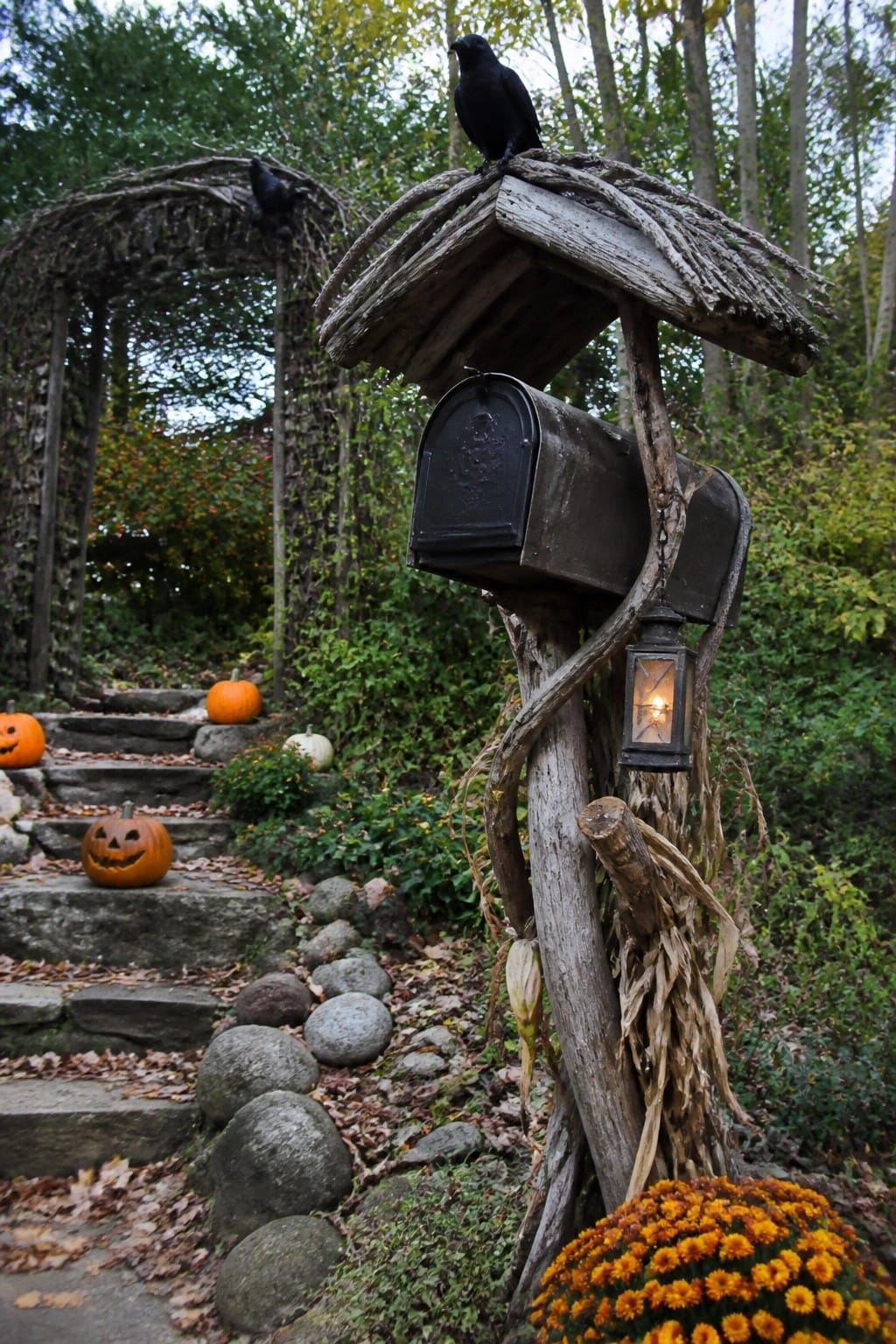 Black crow on rustic mailbox with lantern, pumpkins on autumn stone steps